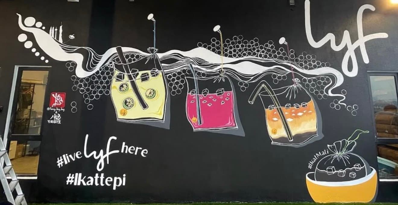 Black mural featuring three colorful iced drinks in plastic bags with white swirls and text.