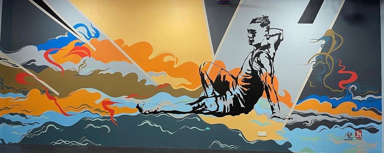 Stylized mural of a man reclining against vibrant, colorful abstract waves and geometric shapes.